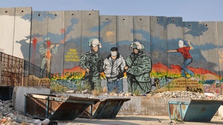 Palæstinensisk grafitti på muren, der deler Vestbredden og Israel. 